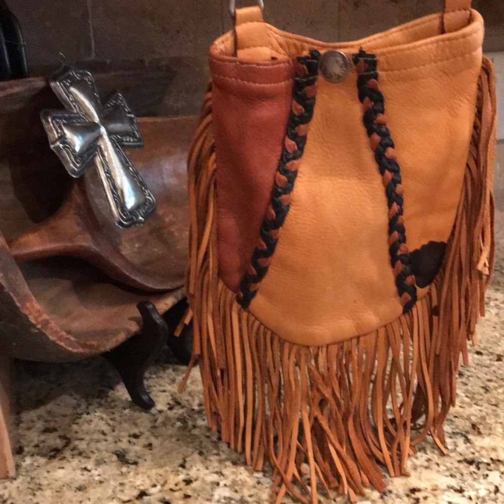 8 1/2x7 1/2 pocket space. 5 1/2 inch fringe. Attachments to wear on belt loops.
